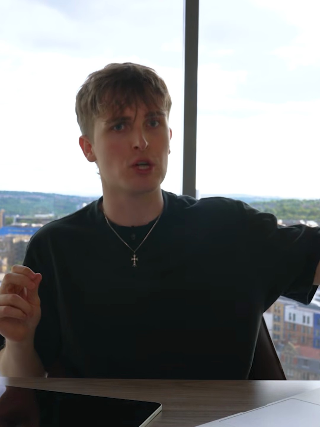 Jake Trinder at his desk above the Newcastle skyline